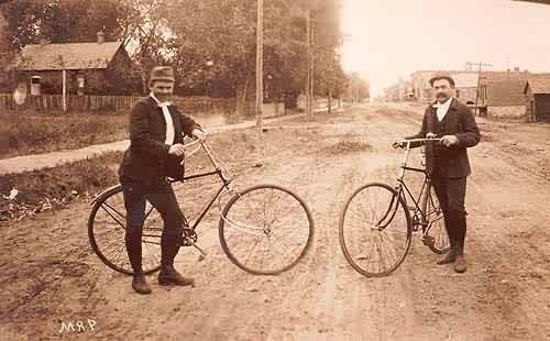 Two Men on Bikes on West Pearl Street