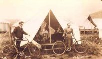 Two People with Bikes in Front of Tent at Chautauqua